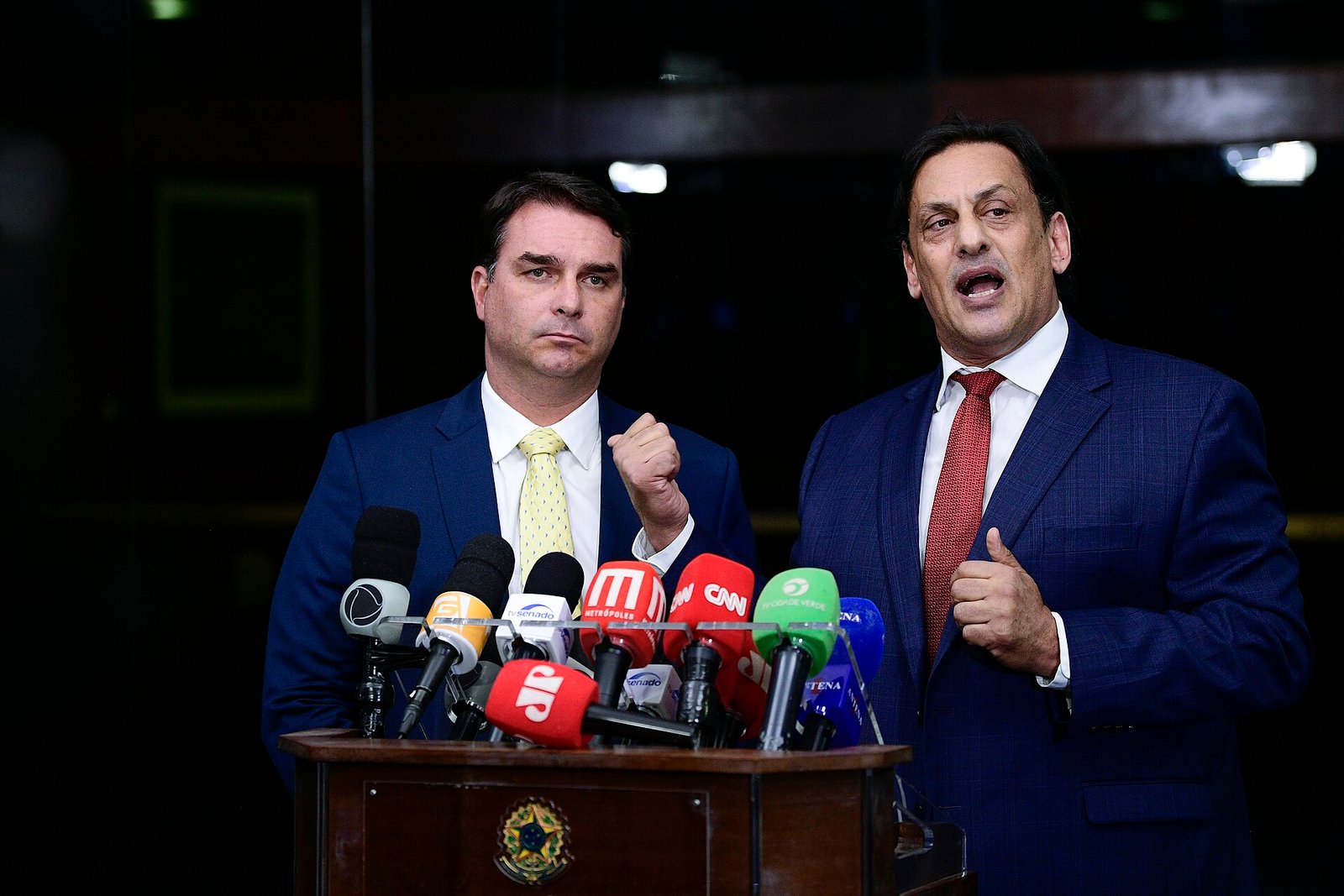 Senator Flávio Bolsonaro (left) speaking to reporters at the Brazilian Senate