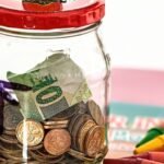 A piggy bank on a table representing small regular savings invested in index funds