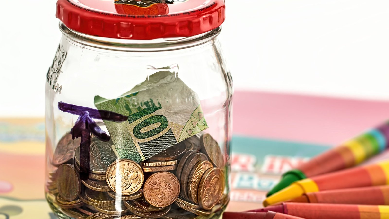 A piggy bank on a table representing small regular savings invested in index funds