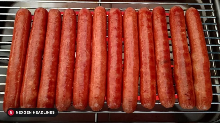 Hot dogs lined up on a grill rack