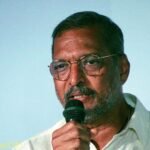 Nana Patekar speaking into a microphone at IFFI Goa in 2017