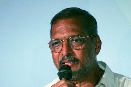 Nana Patekar speaking into a microphone at IFFI Goa in 2017