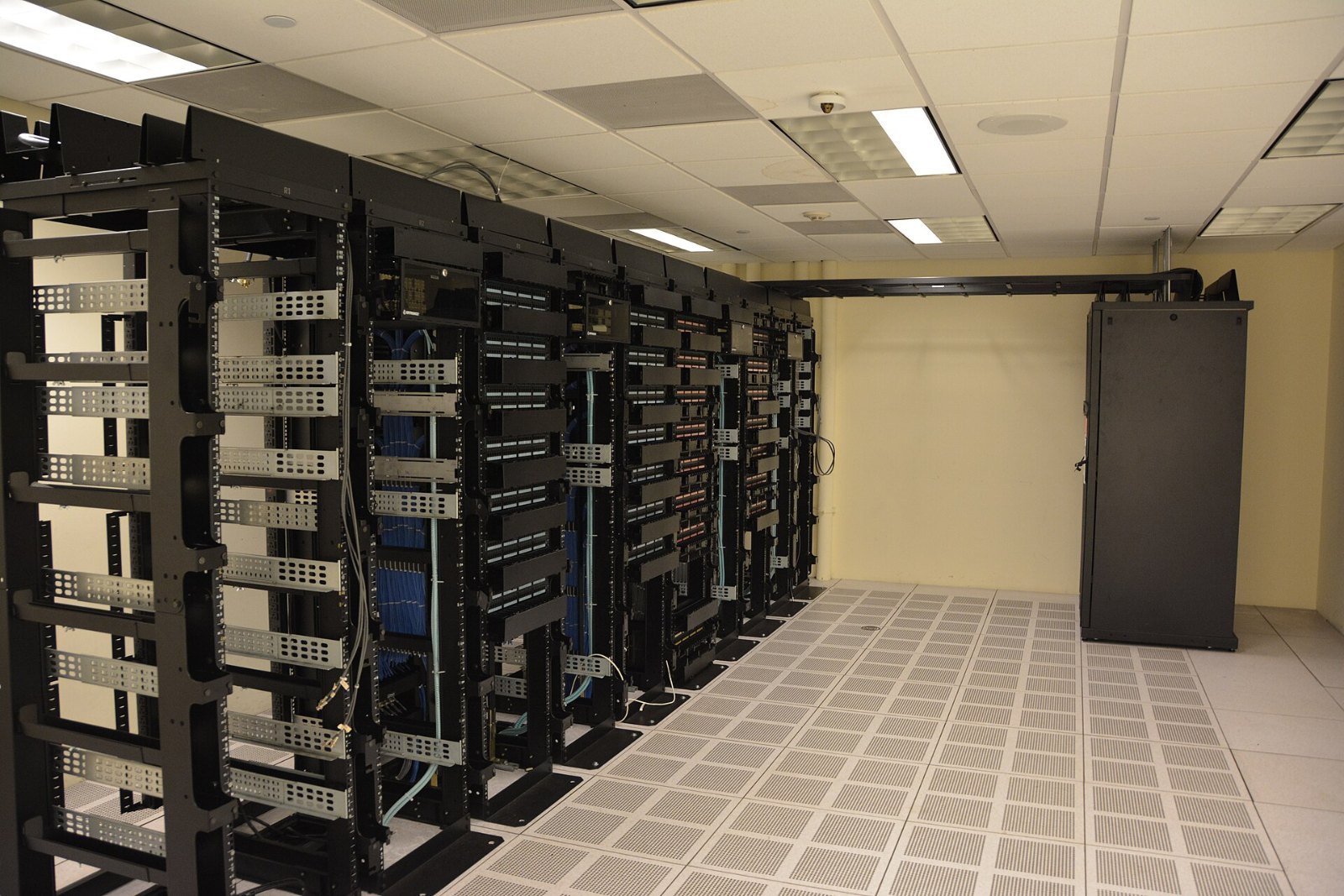 Black server racks lined up in a data center room