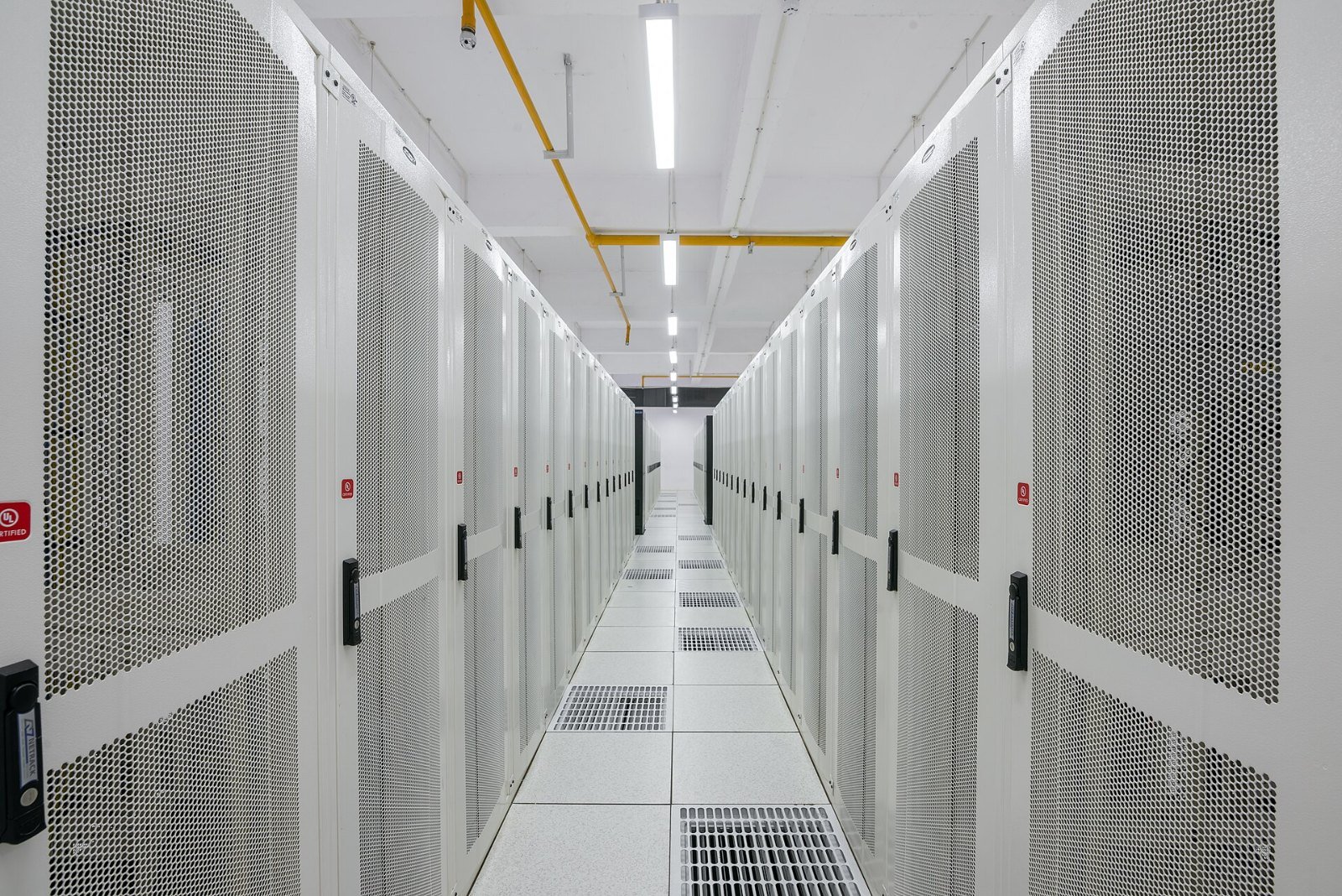 Rows of server racks in a data center aisle