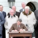 President Ronald Reagan signs the Social Security Amendments of 1983 on the White House South Lawn
