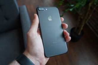 A hand holding a black smartphone