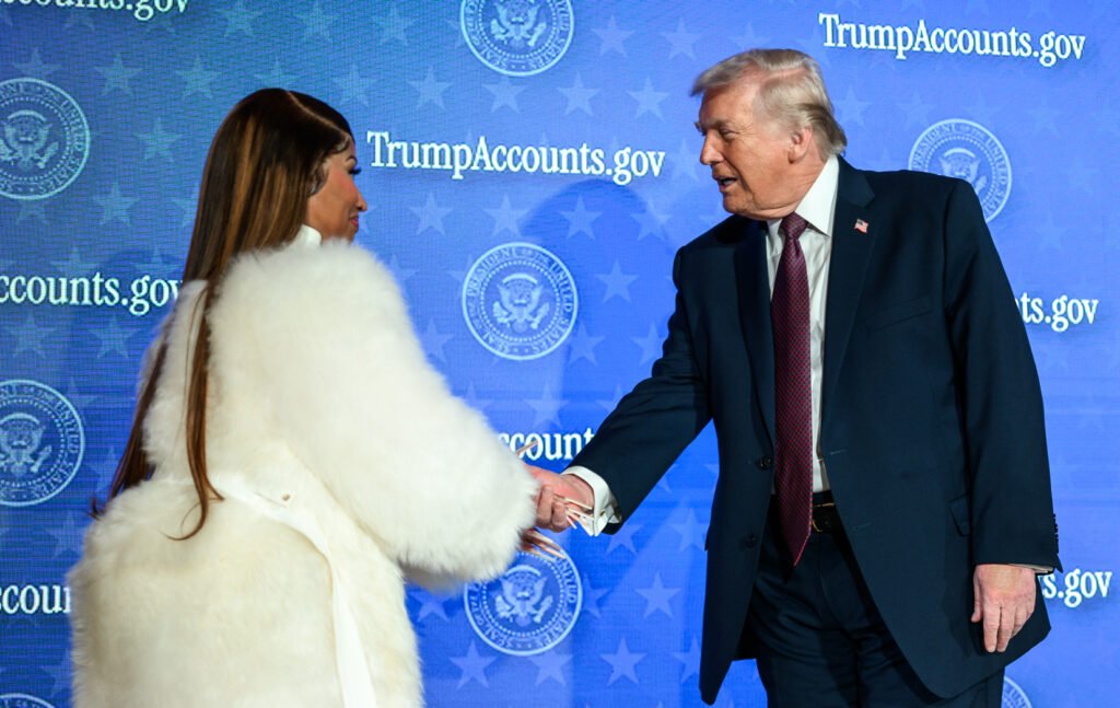 President Trump on stage at a Trump Accounts event in front of a TrumpAccounts.gov backdrop