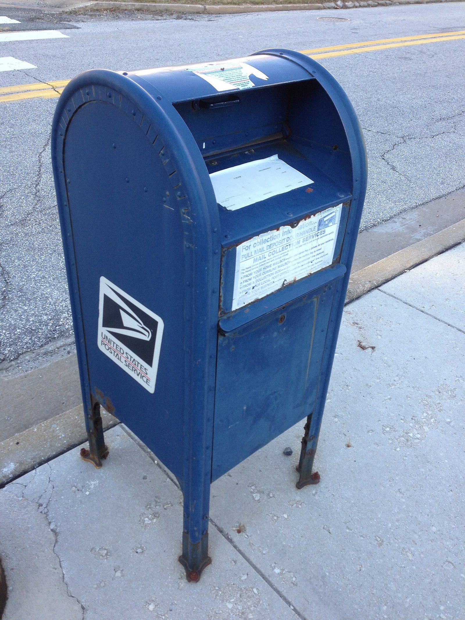 A blue United States Postal Service mailbox